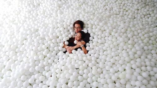Couple relaxing in pool balls