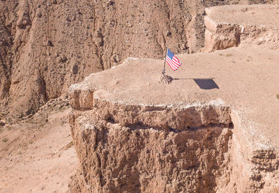 High angle view of american flag flying over rocks