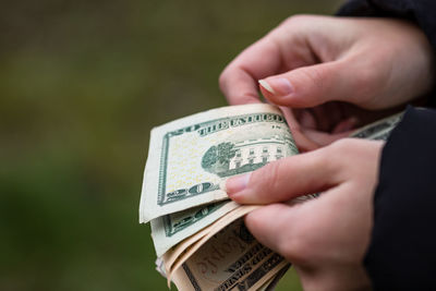 Close-up of hand holding paper