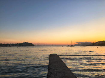 Scenic view of sea against clear sky during sunset