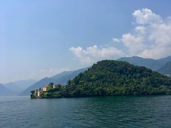 Scenic view of sea and mountains against sky