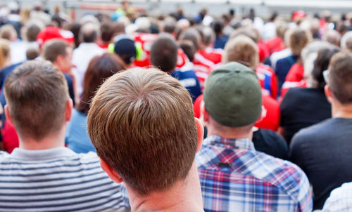 Rear view of people at beach in city