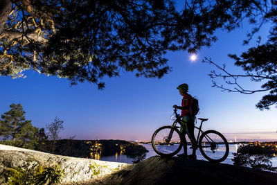 Cyclist at dusk looking at view