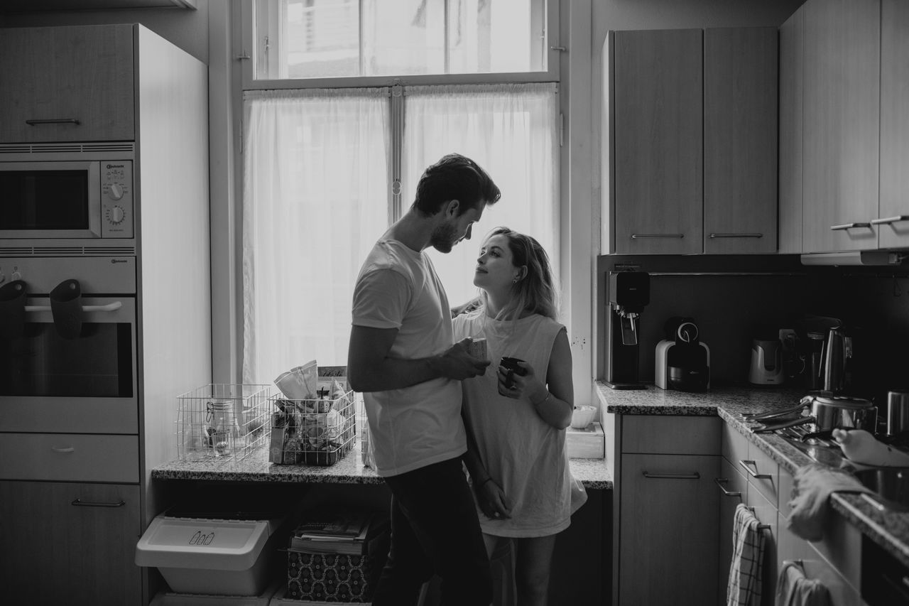 Couple standing in kitchen at home