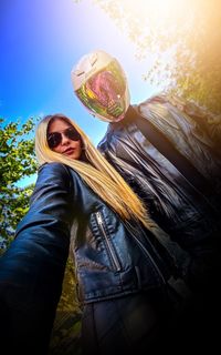 Portrait of woman wearing sunglasses against sky