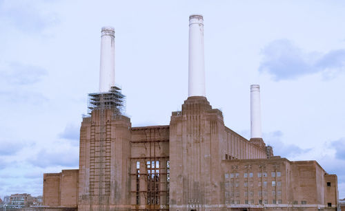 Low angle view of smoke stack against sky