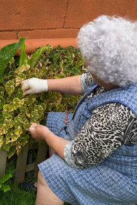 Midsection of woman holding flower pot