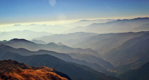 Scenic view of mountains against cloudy sky