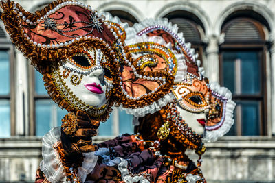 Close-up of woman wearing venetian mask and costume