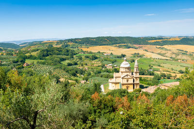 Scenic view of trees and buildings against sky