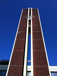 Low angle view of building against clear blue sky