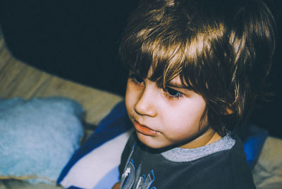 Close-up of boy looking away at home