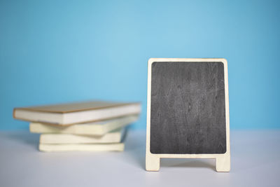 Close-up of telephone on table against blue background