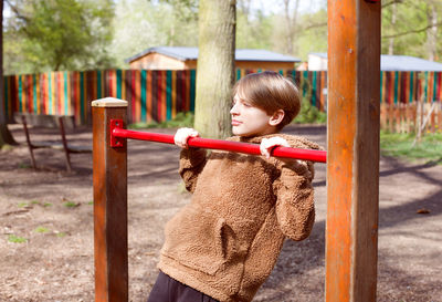 Portrait of boy standing in park