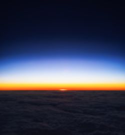 Scenic view of sea against clear sky at sunset