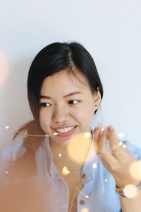 Portrait of a smiling young woman holding hands