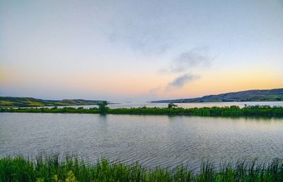 Scenic view of lake against sky during sunset