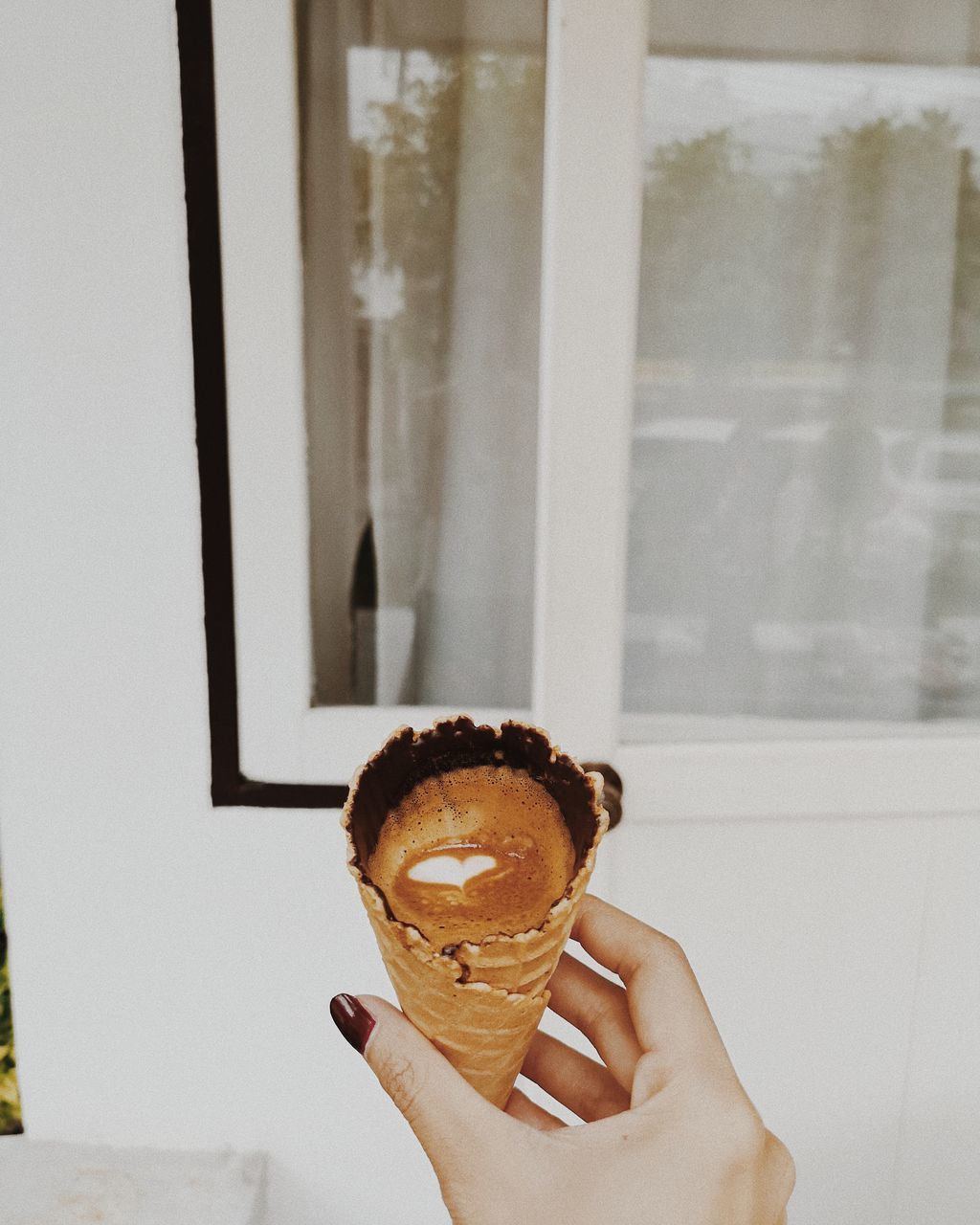 PERSON HOLDING ICE CREAM CONE