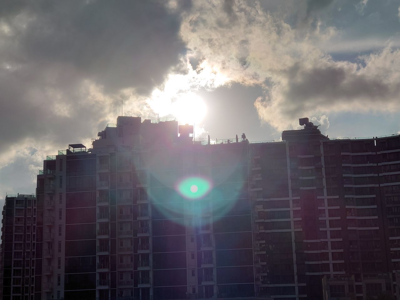 LOW ANGLE VIEW OF SUNLIGHT STREAMING THROUGH BUILDING