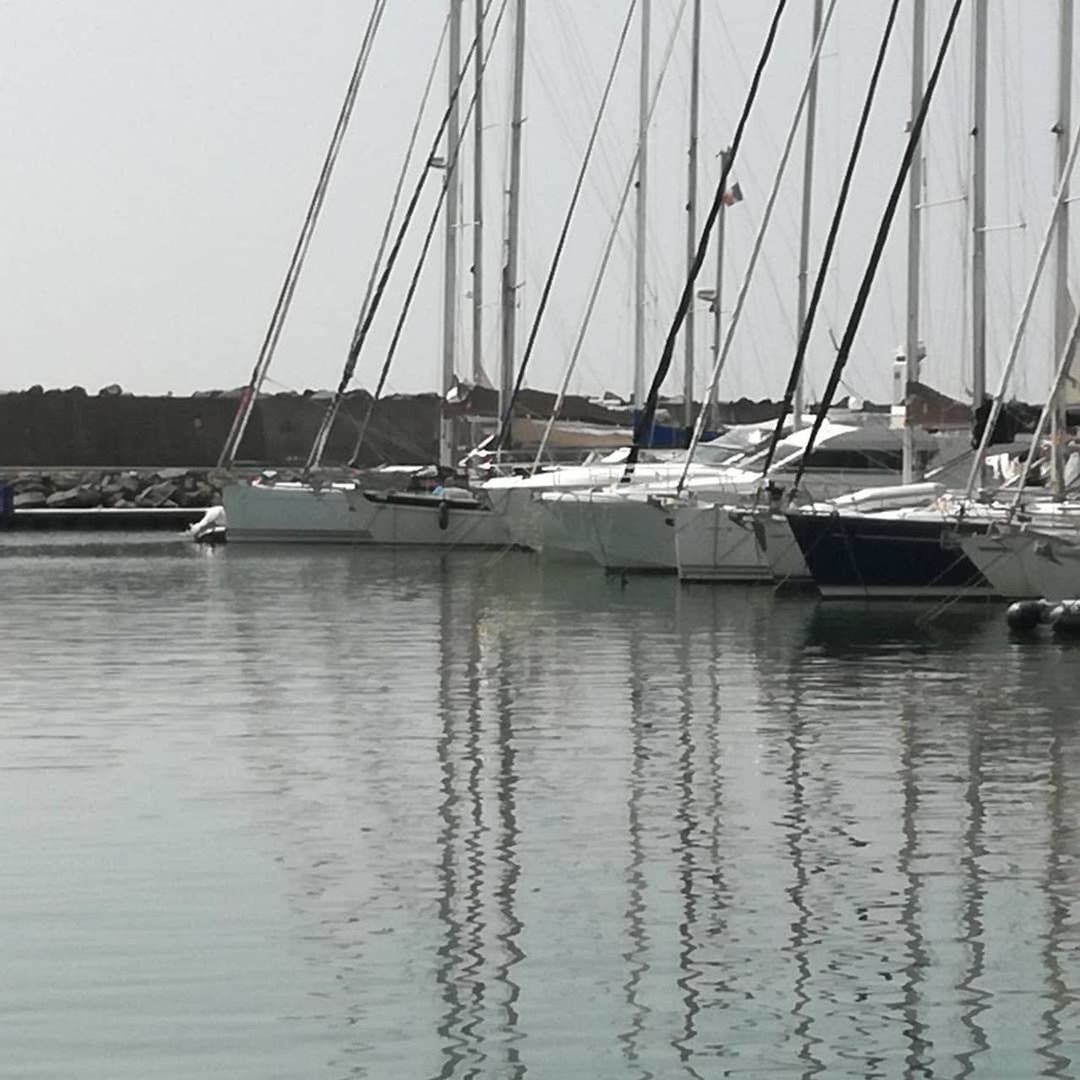 SAILBOATS MOORED ON MARINA