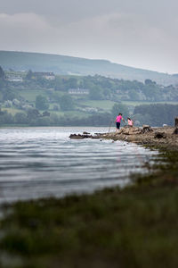 Man on horse at beach against sky
