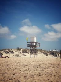 Lifeguard hut on beach against sky