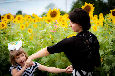 Happy girl and woman on field