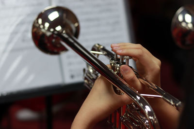 Cropped hands of person playing musical instrument