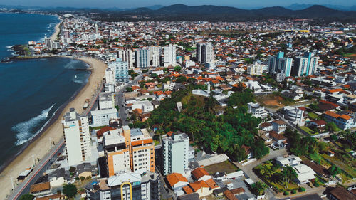 High angle view of townscape by sea