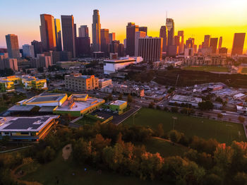 High angle view of buildings in city against sky during sunset