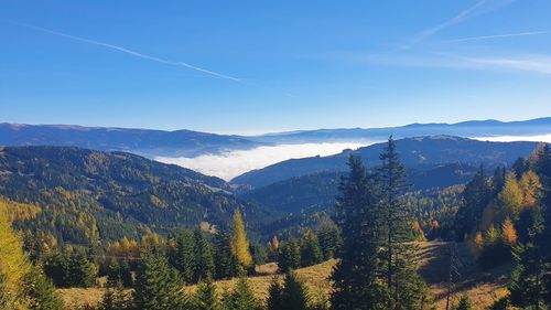 Scenic view of mountains against blue sky