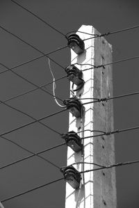 Low angle view of people on building against clear sky