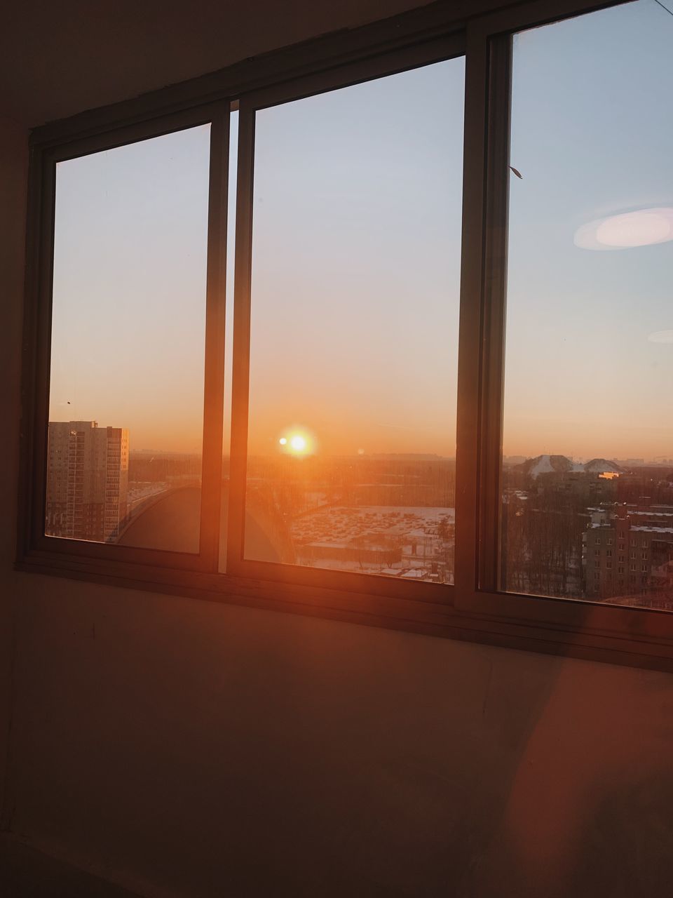 SCENIC VIEW OF SUNSET SEEN THROUGH WINDOW