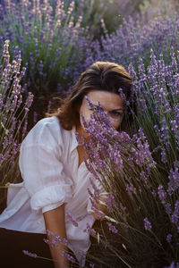 Portrait of young woman sitting on field