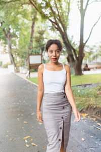 Young african american woman in park, white shirt mock up. fall season