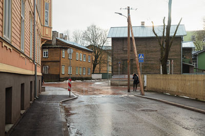 People walking on street amidst buildings in city