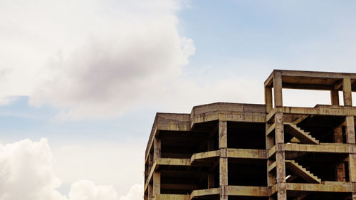Low angle view of abandoned building against sky