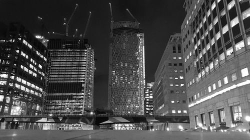 Low angle view of illuminated buildings against sky at night