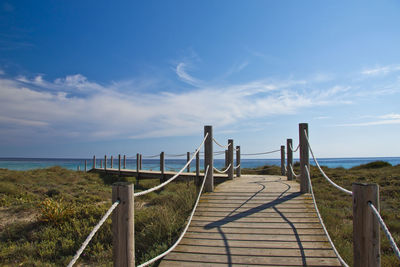 Pier over sea against sky