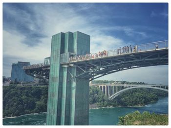Low angle view of bridge against cloudy sky
