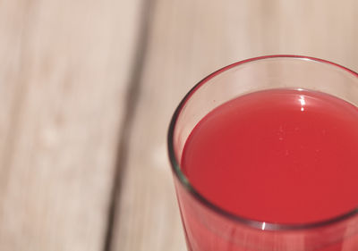 High angle view of red drink on table