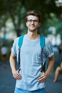 Portrait of young man wearing sunglasses standing outdoors