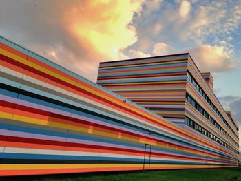 Low angle view of building against cloudy sky