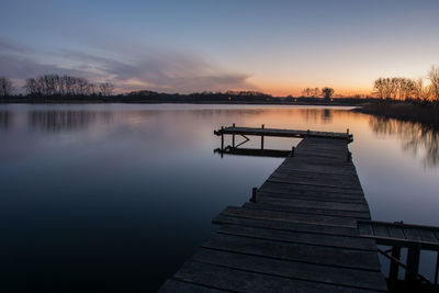 Long jetty on the lake and a colorful sky and clouds after sunset