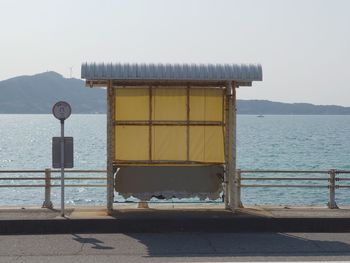 Built structure by sea against clear sky