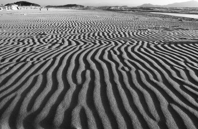 Scenic view of sand dunes against sky