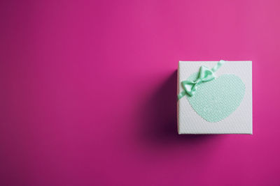 Close-up of paper box against pink background