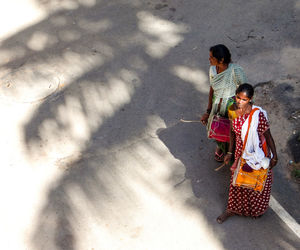 High angle view of people playing drums while standing on road