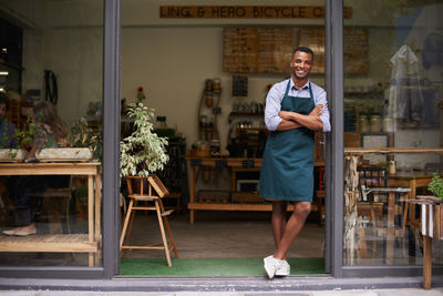 Full length of man standing in coffee shop