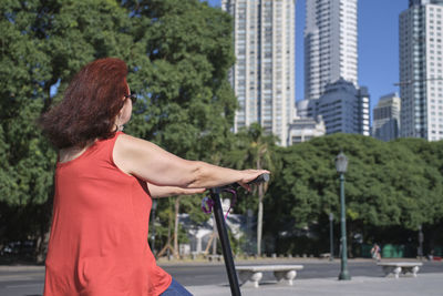 Rear view of woman standing in city